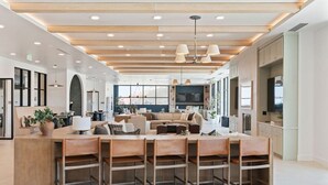 A spacious, modern kitchen with a central island, wooden ceiling beams, and pendant lighting. - Superb NEW 2BR amazing amenities (Salt Lake City)