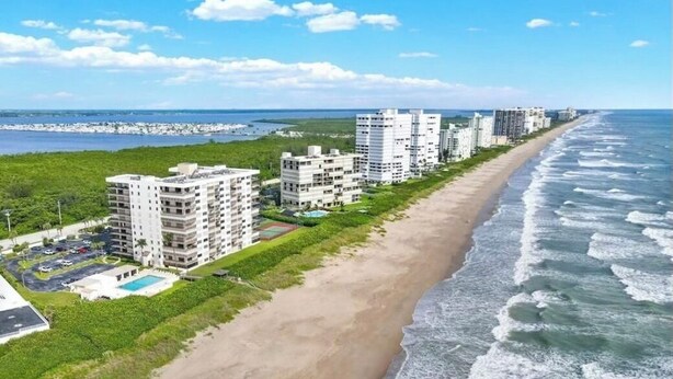 A coastal hotel with multiple buildings, a beach, and ocean views.