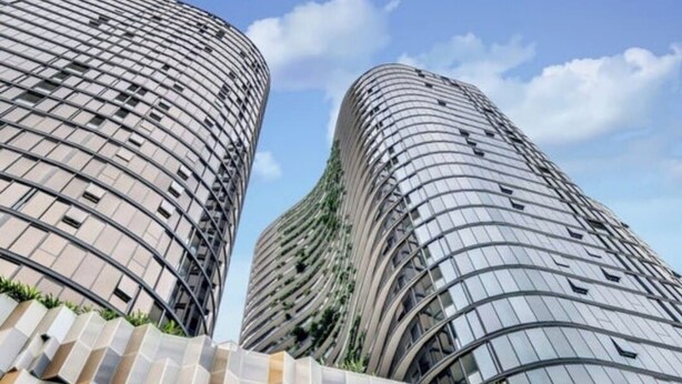 Two high-rise buildings with a curved facade and a patterned base.
