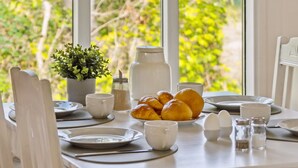 A breakfast table set with plates, cups, a salt shaker, a sugar bowl, a sugar container, and a small potted plant. - "Lavrans" - 1km from the sea by Interhome (Ebeltoft)