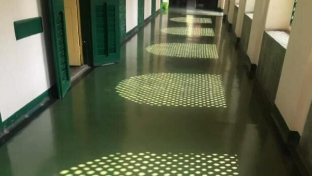A hallway with green walls and a patterned floor. - YWCA GALLWAY GUEST HOUSE (Kolkata)