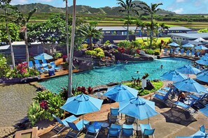 A resort with a swimming pool, lounge chairs, and umbrellas. - Kiahuna Plantation Resort 161 Ocean View 1 Bedroom (Koloa)