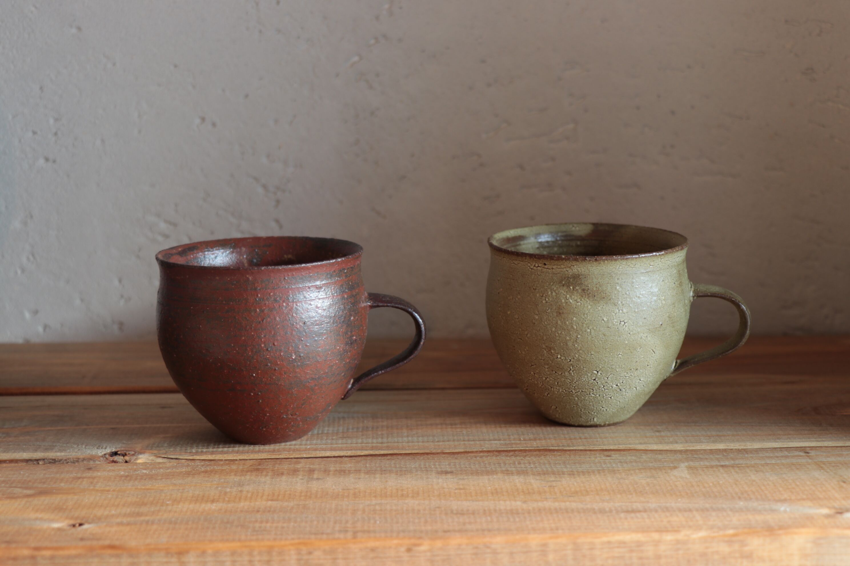 Dos tazas de cerámica sobre una superficie de madera.