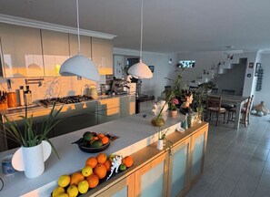 Enjoy cooking in this well-lit kitchen with a central island and dining area.