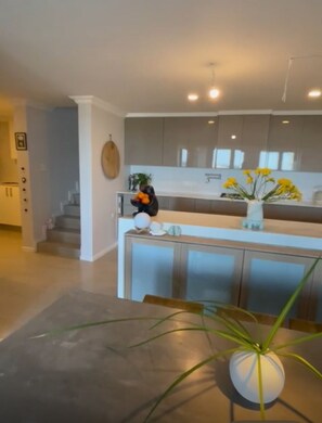 Enjoy cooking in this well-equipped kitchen with a central island and cabinetry.