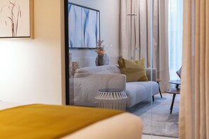 A modern living room with a sofa, a small side table, and a decorative vase.