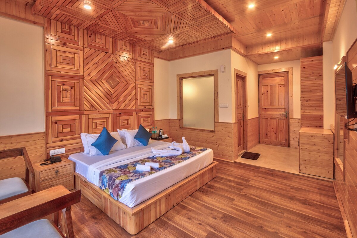 A wooden-paneled bedroom with a bed, bedside tables, and a mirror.