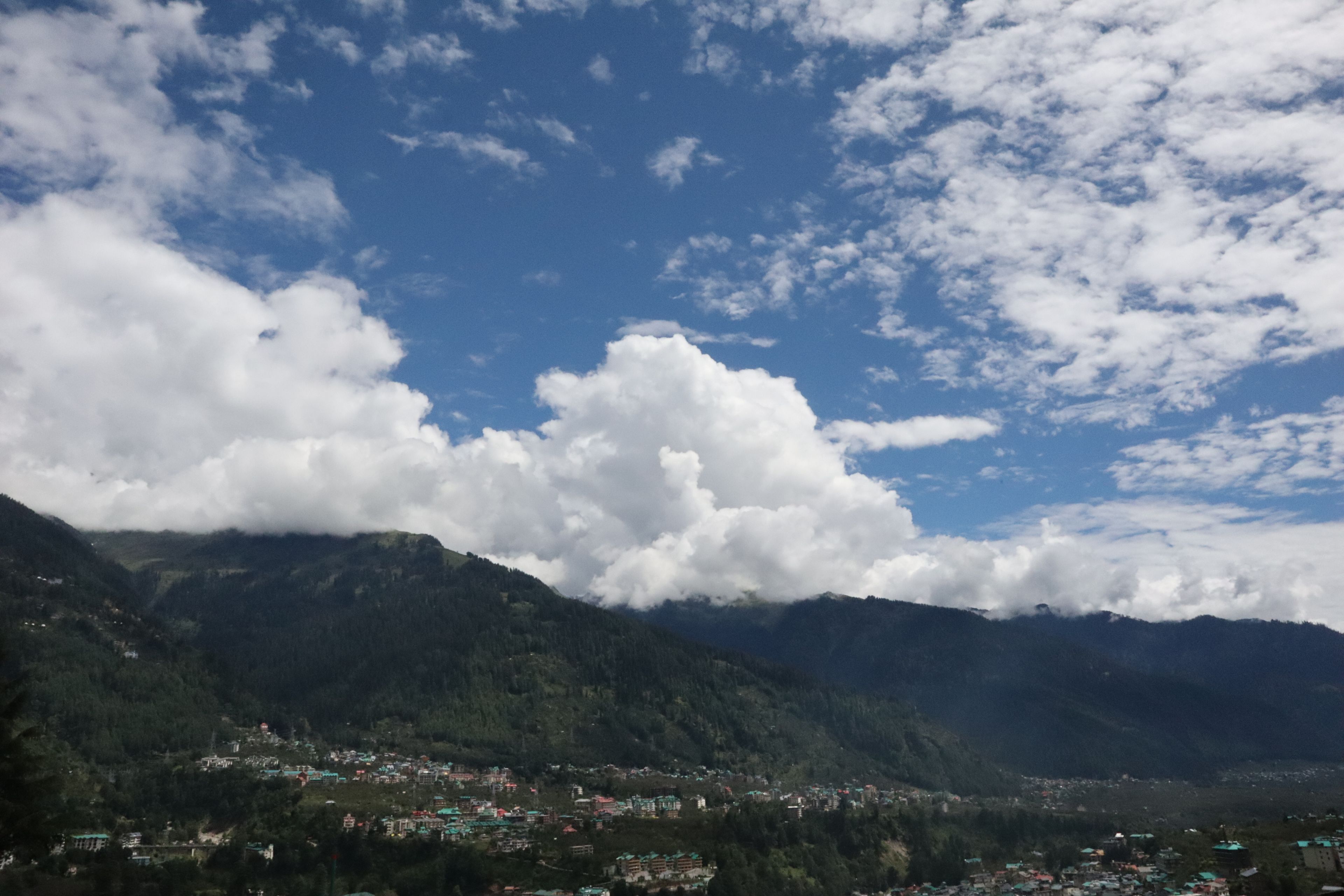 A mountainous landscape with a village nestled in the valley.