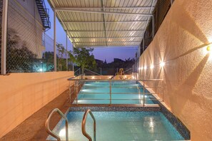 An indoor swimming pool with a covered area, metal railings, and a tiled floor. - Hotel Padmavati Palace Mahabaleshwar (Mahabaleshwar)