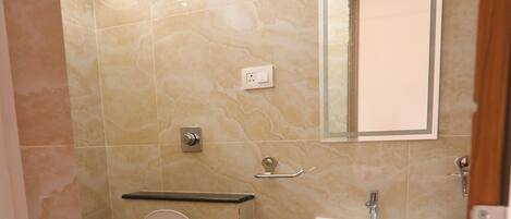 A small bathroom with a toilet, sink, and mirror.