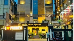 A hotel with a modern facade, a prominent entrance, and a sign that reads "HOTEL PARK SQUARE." - Hotel Park Square  (Purnia)