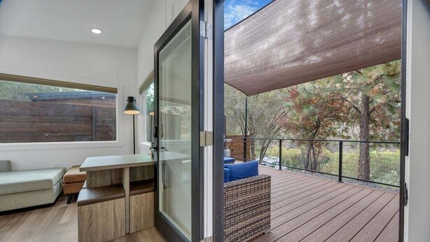 A modern interior with a sliding glass door leading to an outdoor deck.