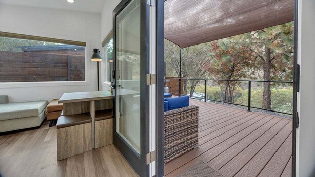 A modern interior with a sliding glass door leading to an outdoor deck.