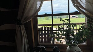 A room with a large window, a wooden desk, a telephone, a horse figurine, and a sign that reads "Welcome". - Log cabin with mountain VIEWS in Lexington! Near VA Horse Ctr, 8 mi from VMI/W&L (Lexington)