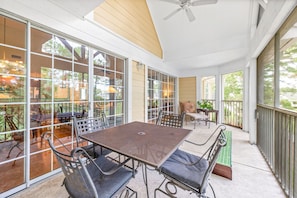 Enjoy dining or socializing in this outdoor space with a large table and comfortable chairs.