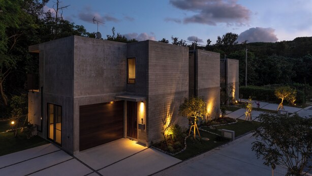 A modern house with a garage, a well-lit entrance, and a landscaped garden. - RYUKYU BREEZE (Nago)