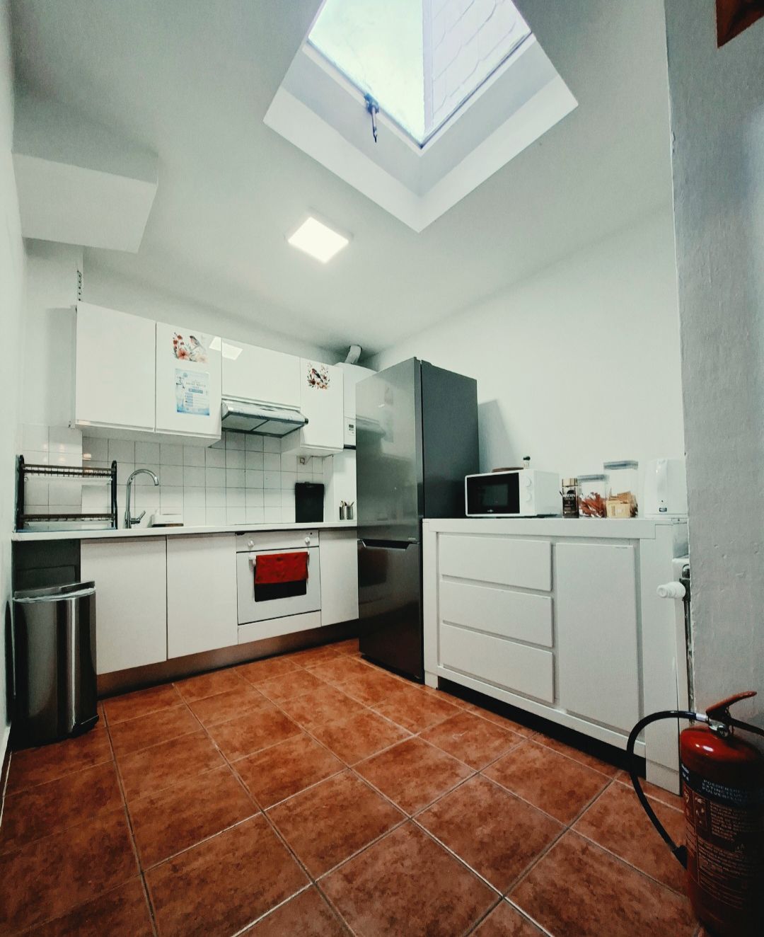 stovetop, refrigerator, microwave, kitchen visible, daytime