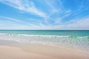 A beach with clear skies and calm waves.