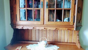 A wooden cabinet with multiple glass doors and drawers, likely used for storage.