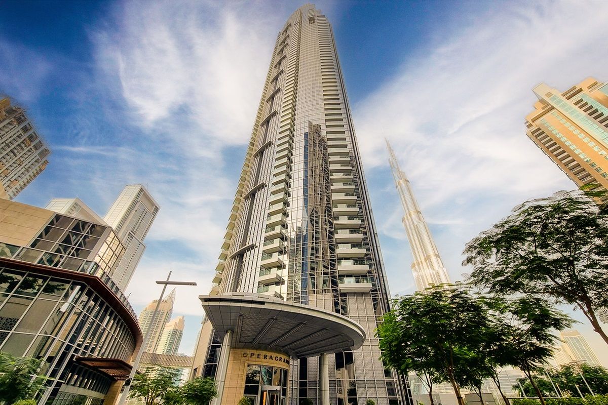 A high-rise building with a curved entrance and multiple floors.