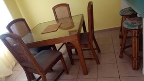 Enjoy meals in this dining area with a glass-top table and comfortable seating for four.