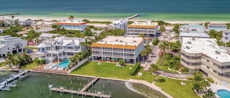 A coastal hotel with multiple buildings, a swimming pool, and a marina.