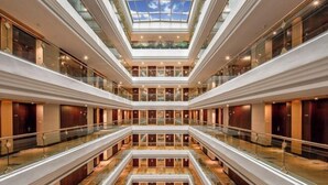 A multi-level atrium with glass railings and a central open space.