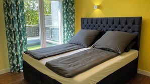 A bedroom with a bed, curtains, and a window. - Vacation home near Katowice  (Bytom)
