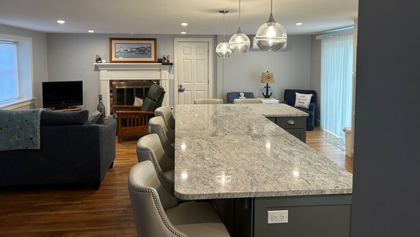 A modern living room with a large island, a fireplace, and a dining area. - Close to BEACH! Falmouth / Falmouth Heights 4Bdr-2Ba. 2025 Renovation Large Deck (Falmouth)