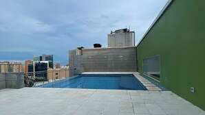 A rooftop pool with a clear view of the city skyline.