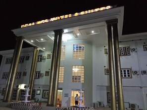 A hotel with a grand entrance, large columns, and a sign above the entrance. - Dealings Hotel and Suites  (Ijebu Ode)