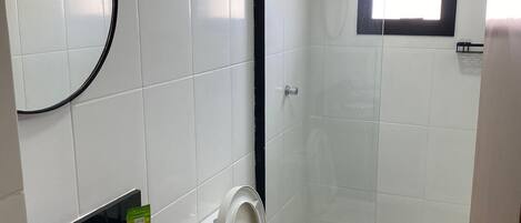 A bathroom with a toilet, bidet, and sink.