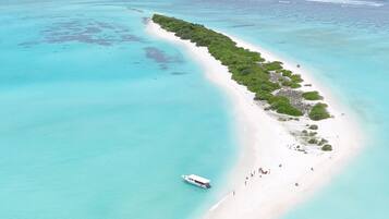 Beach nearby, white sand, beach umbrellas, beach towels