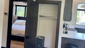 A modern interior with a bedroom, a bathroom, and a kitchenette. - Brand New, Luxury 1-bedroom apartment with AC, 10 Minutes to Downtown Whitefish (Whitefish)
