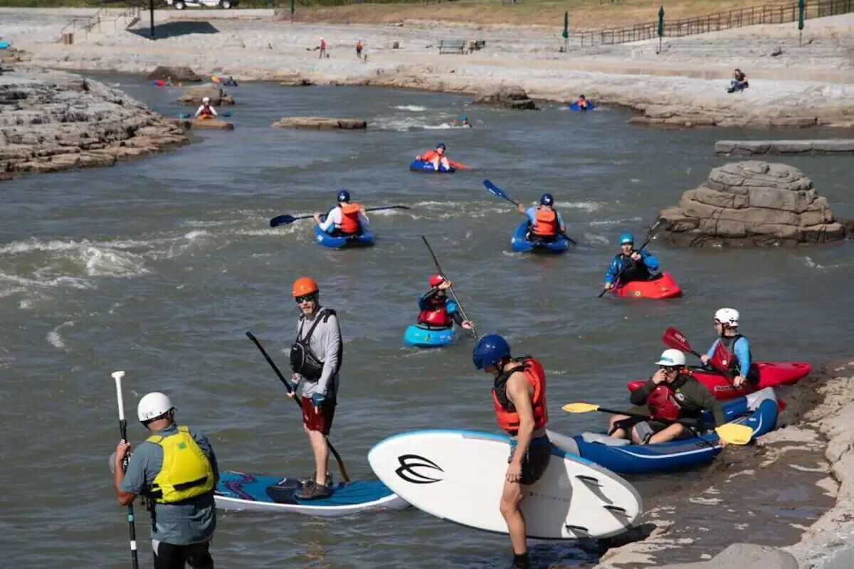 A group of people kayaking on a river.
