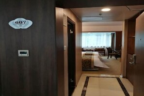 A hotel hallway with a sign indicating room number 607, leading to a room with a bed and a window. - Mingyue Business Hotel(Huaqiang North subway station store) (Shenzhen)