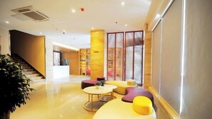 A lobby with a staircase, seating areas, and a reception desk. - Lavande Hotel Guilin Railway Station Elephant Trunk Hill Scenic Area (Guilin)