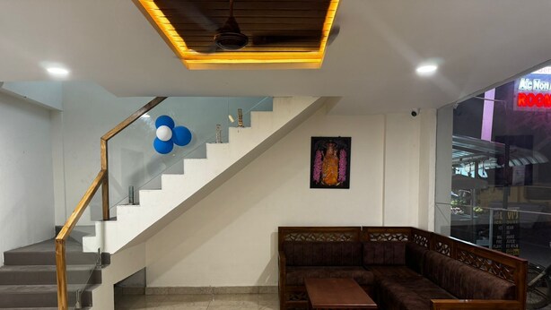 A modern interior with a staircase, a sectional sofa, and a small table. - L D Residency (Kilvelur)