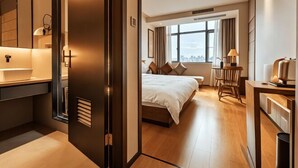 A modern hotel room with a bed, bedside table, lamp, and a view of the city through large windows. - WGSY Hotel (Hefei Economic Development Zone Mingzhu Square University Town) (Hefei)