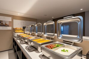 A buffet setup with multiple food dispensers. - WGSY Hotel (Hefei Economic Development Zone Mingzhu Square University Town) (Hefei)