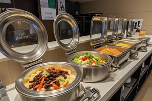 A buffet with various food options, including pasta, salad, and other dishes. - WGSY Hotel (Hefei Economic Development Zone Mingzhu Square University Town) (Hefei)