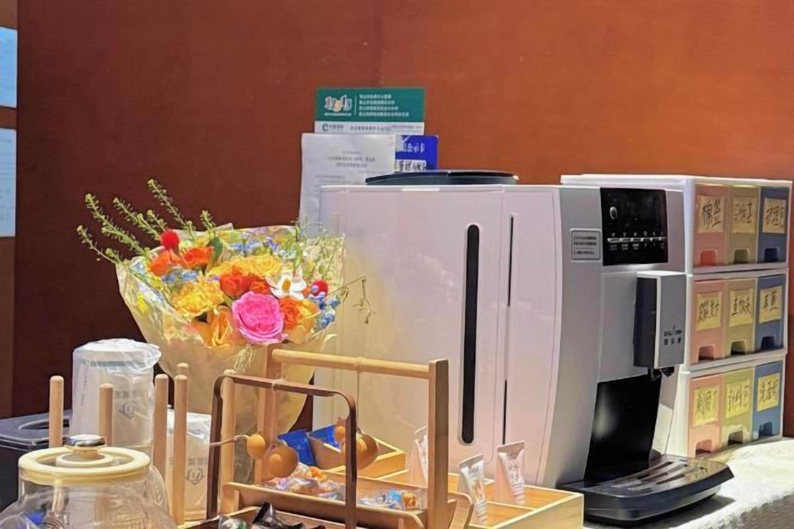 A refrigerator, a microwave, and a display of beverage cartons on a counter.