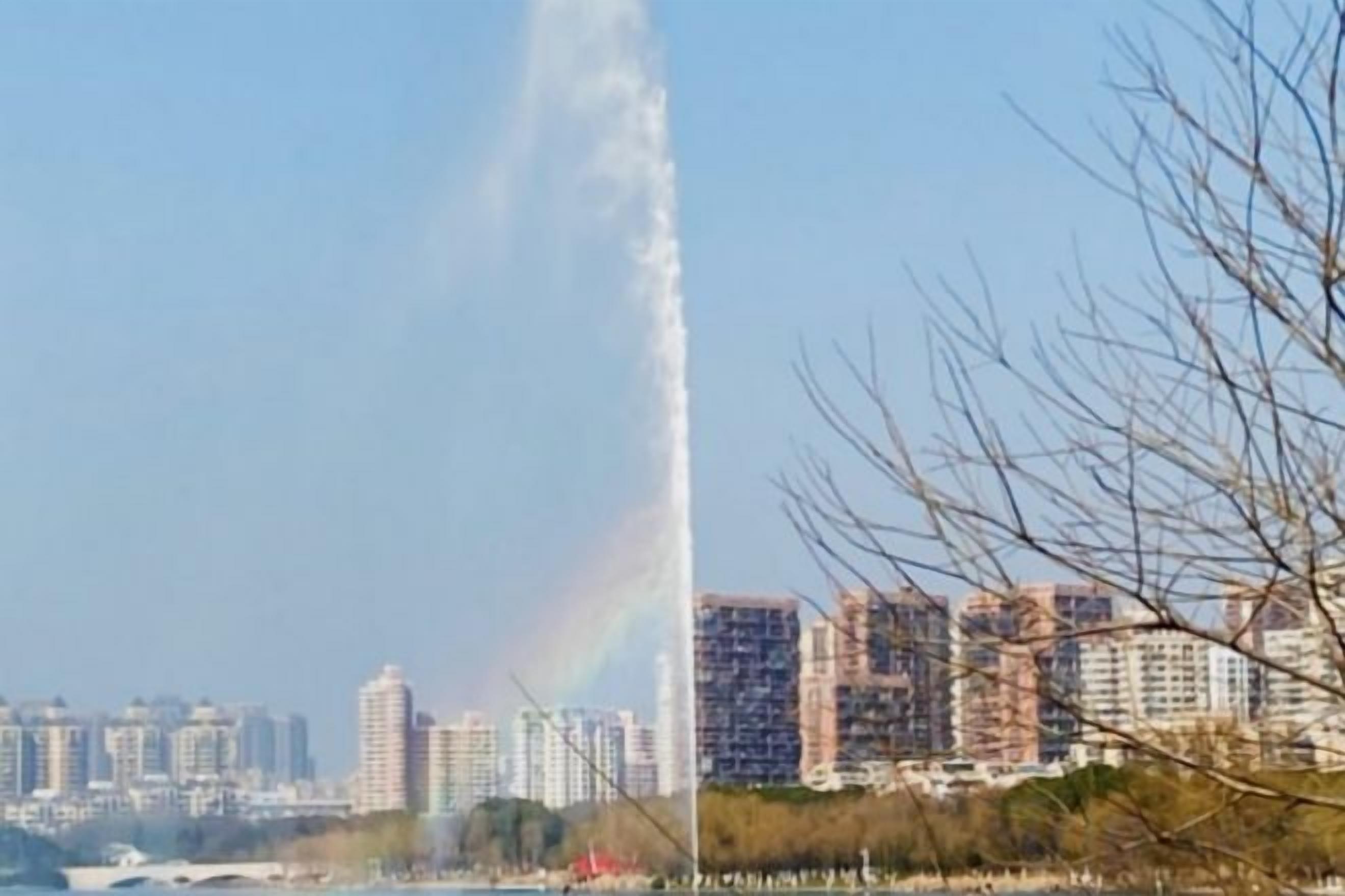 A cityscape with high-rise buildings and a visible water jet.
