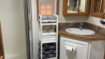 Shower, hair dryer, towels, toilet paper