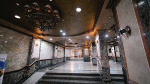 A marble-floored lobby with a grand chandelier, a staircase, and a reception area. - MAKAI Pyramids Guest House (Giza)