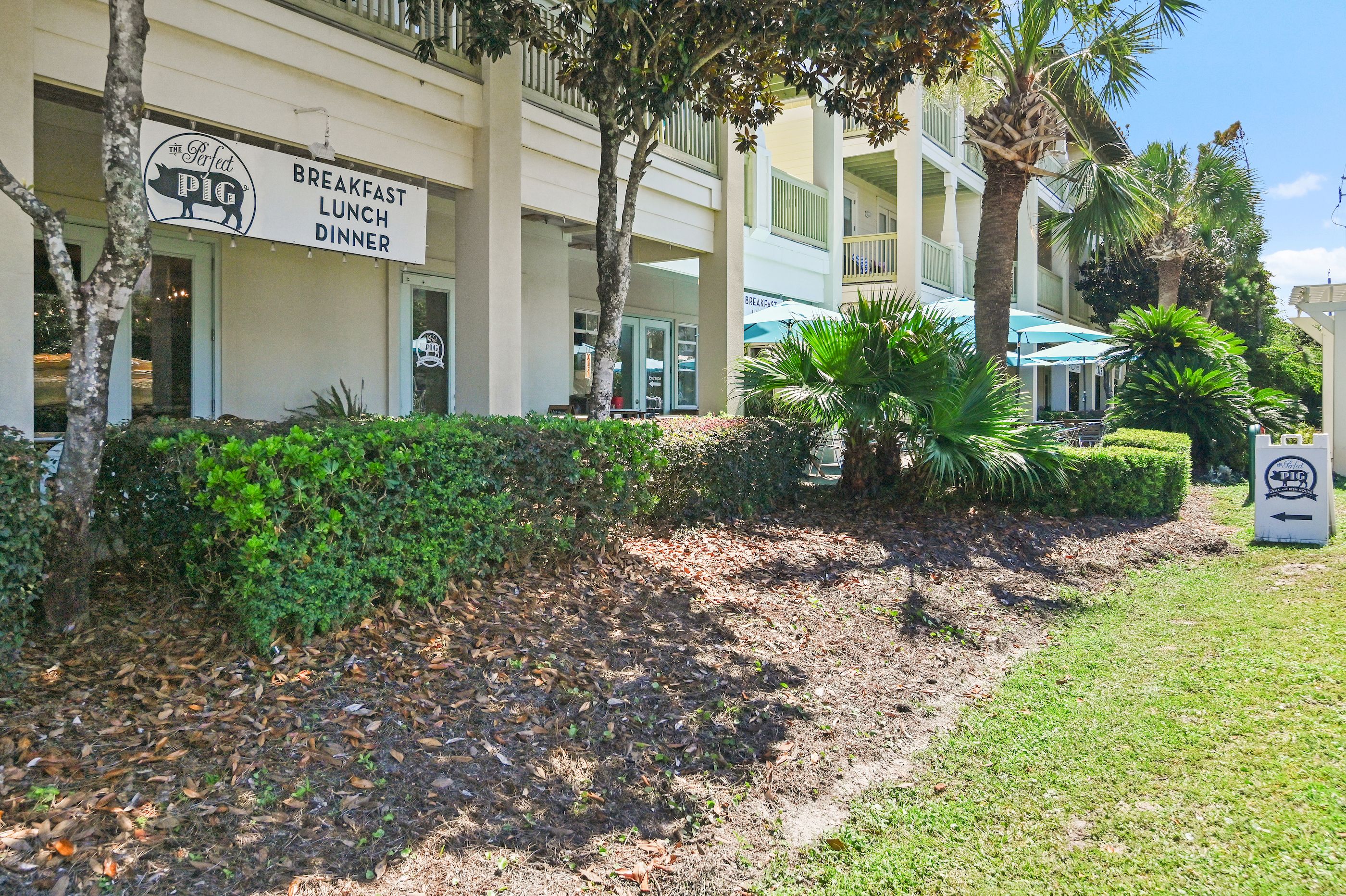 A building with a sign indicating breakfast, lunch, and dinner services.