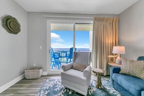 Relax in this stylish living room with a balcony offering ocean views.