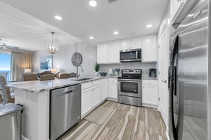Enjoy cooking in this well-equipped kitchen with a dishwasher, oven, refrigerator, microwave, and coffee maker.