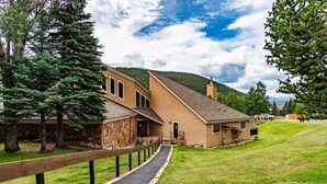 A two-story building with a stone facade and a wooden deck. - Spacious Keystone Family Escape Great Location (Keystone)