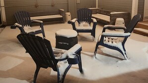 An outdoor patio area with snow-covered chairs and string lights. - Guest Favorite, Peaceful, Walkable to Dinning & Shopping. 5-Star clean! (Coeur d'Alene)